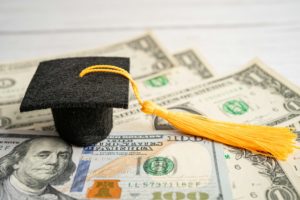 Graduation gap hat on US dollar banknotes money, Education study fee learning teach concept.