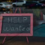Help wanted sign in a restaurant, shop, store, or small business window
