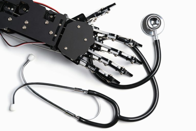 Real Robotic Hand with Stethoscope. Concept of Artificial Intelligence and Robots in Medicine